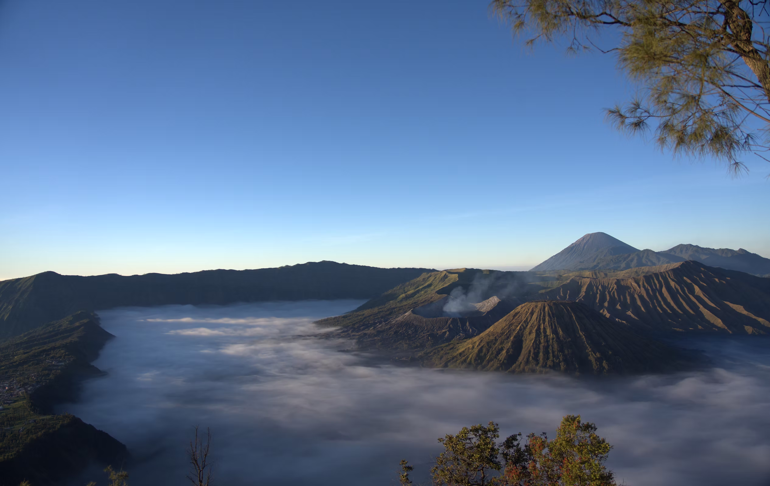 Sunrise over volcanic mountains and a valley of clouds in Indonesia